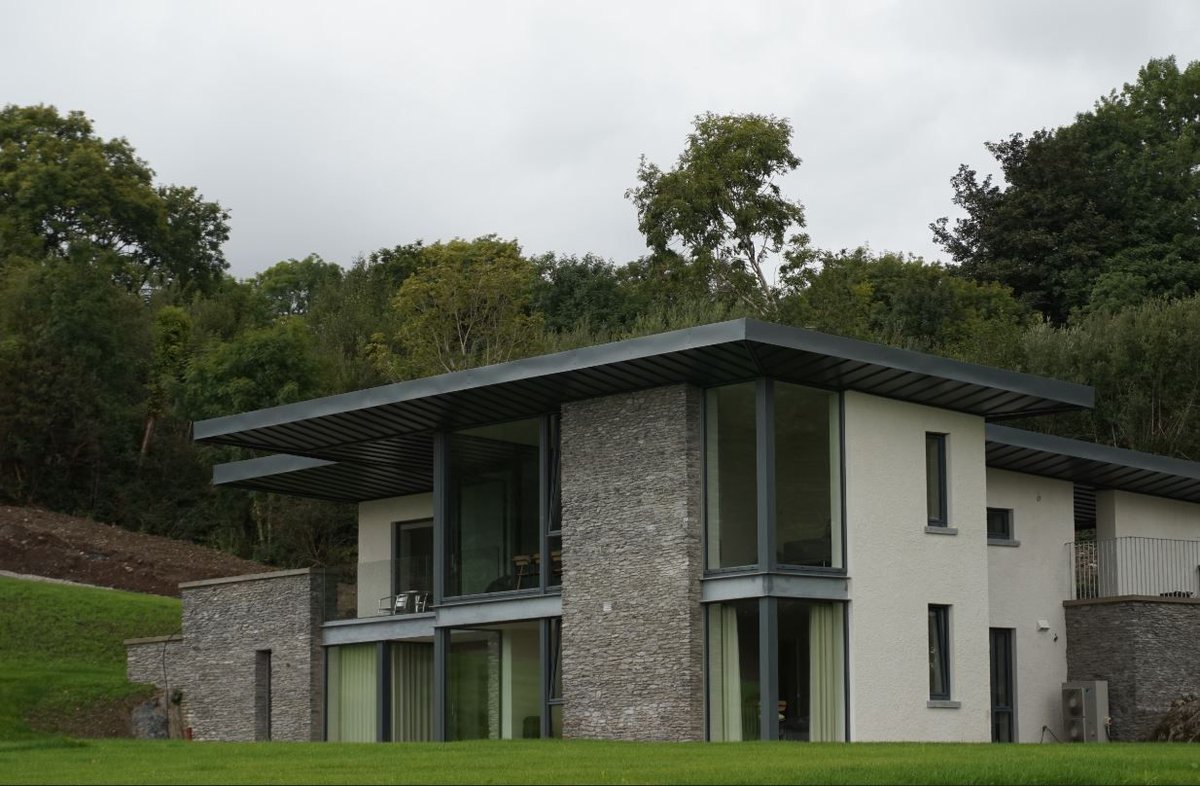EQCIreland's tweet photo. This beautifully-designed #contemporary home cuts a striking figure in a green landscape in West Cork (product featured: Seamlock® Colorcoat Prisma®) #cladding #residentialcladding https://t.co/4hCqtcdbqL