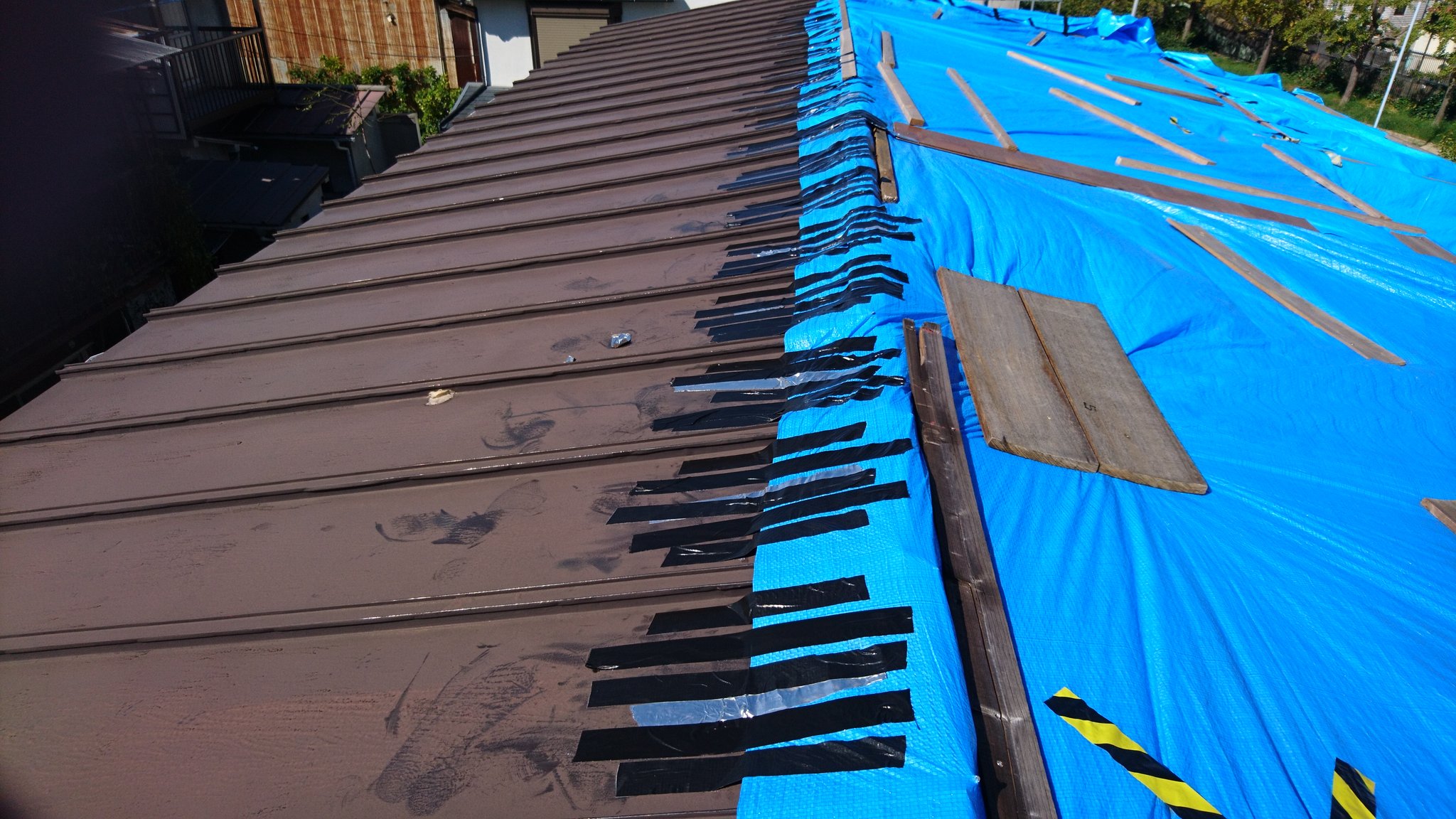 Dmnao 台風24号に備えて何もしないわけにはいかないので ブルーシートと屋根を強力粘着テープで補強した ブルーシートは板で押さえてネジ釘で固定しているけど 風で隙間ができると雨漏りするから 粘着テープで隙間を押さえた 素人で出来るのはここ