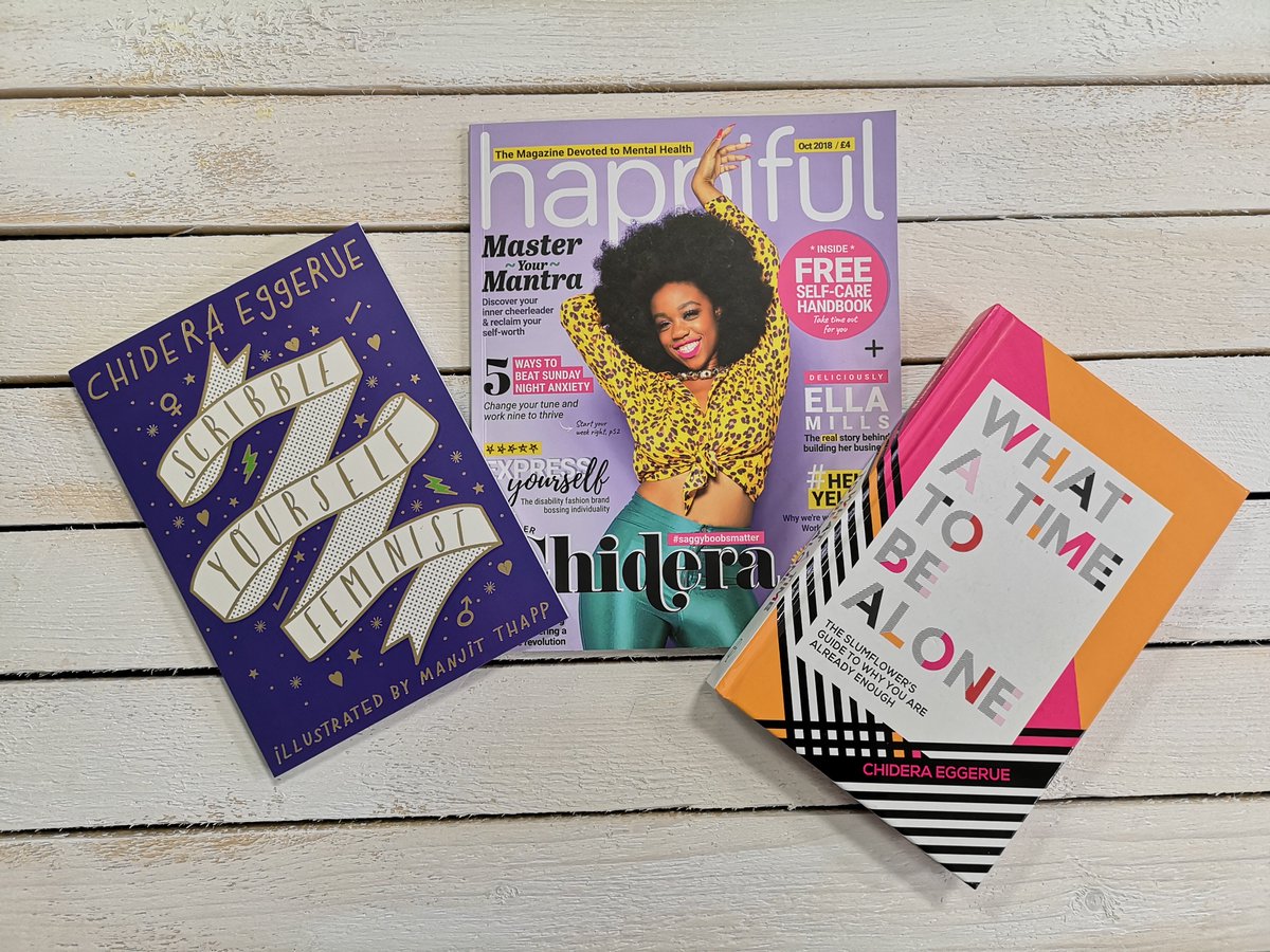 the book 'Scribble Yourself Feminist', the oct issue of Happiful magazine and the book 'What a Time to Be Alone' on a wooden background