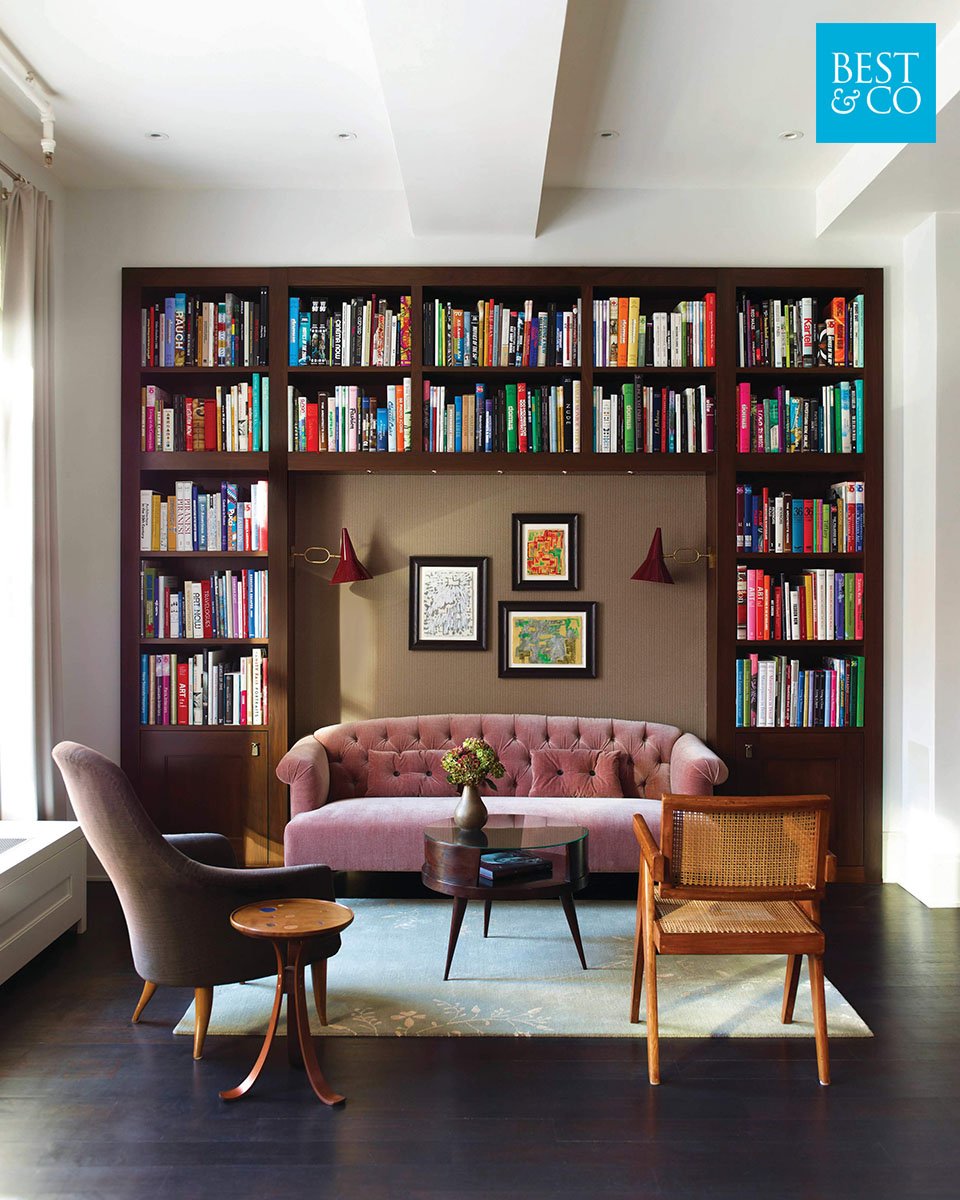 Built in bookcases and colorful books makes for one super interesting accent wall. We just love how all the colors in this design work so well together. Plus that velvet pink sofa is just fabulous!