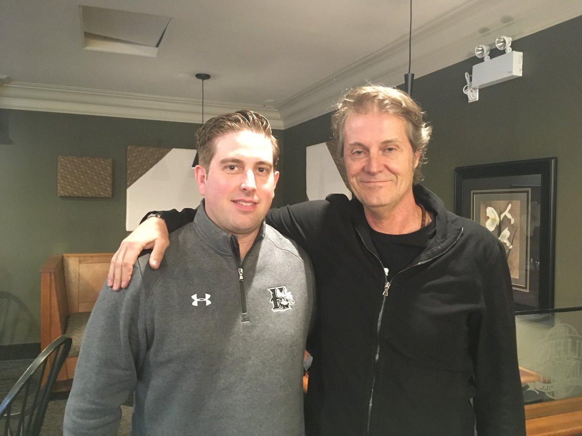 HFXMooseheads's tweet photo. You just never know who you’ll run into on the road🙂 Coach Favreau with Jim Cuddy of Blue Rodeo in Port Hawkesbury. Fact: Sly plays a mean xylophone. https://t.co/TYJrjYEYyG