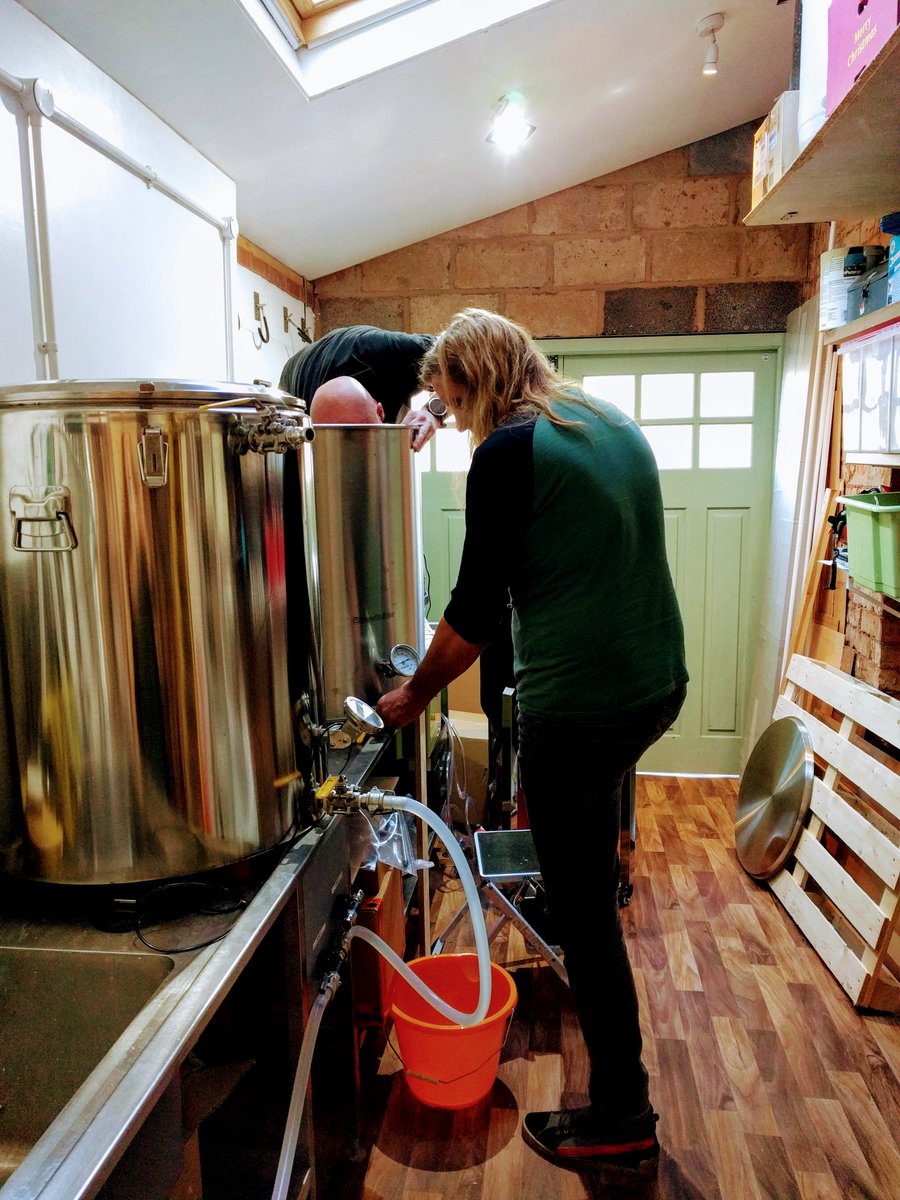 Mashionistas's tweet photo. So, first mash for test brew is ON (lovely to wake up to water already at temperature; got a lie in!). The boys are currently pondering the boil... Or is Jon trying to encourage Simon into the pot?? Also, Jon will be putting his lustrous locks into a ponytail any mo now #TestBrew https://t.co/dKBbZSl4zT