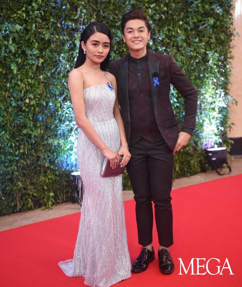 mega_magazine's tweet photo. @vivoree’s jet black hair complemented her white stunning dress by Steph Tan and @hashtag_ck’s maroon three-piece suit by @aveldesigns. #ABSCBNBall2018 https://t.co/GnMeDZGMcK