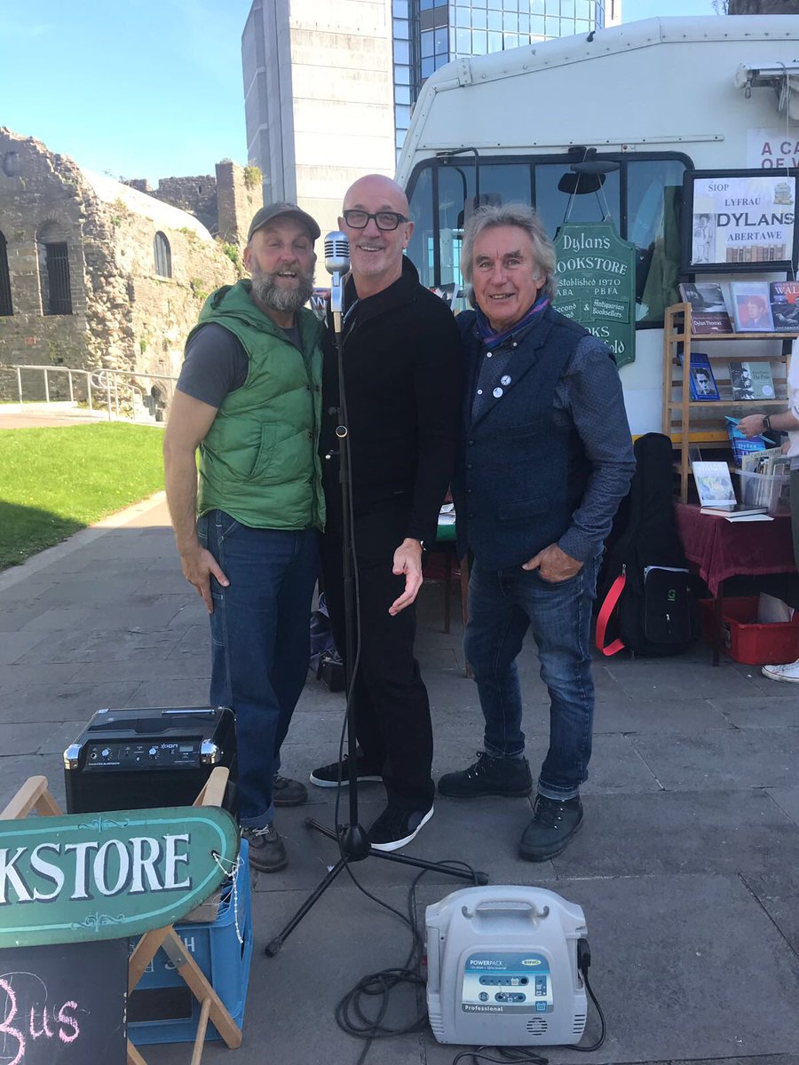 SwanseaFestMA's tweet photo. Here’s @mrmarcrees, @malpope and  @Dylanthomasguy enjoying Now for More’s POETRY NOW! in Castle Square earlier today. Plenty of time to get down there and get involved - it runs until 18:00 #NowForMore https://t.co/CUZtdrBP6i