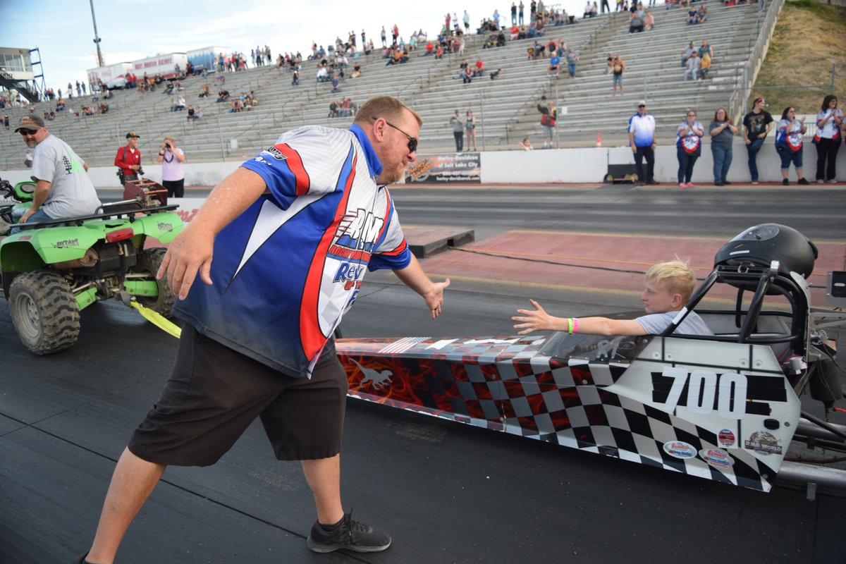RMRSLC's tweet photo. @RMRSLC General Manager @MikeRMRGM reaches out to a young Jr. Drag Racer during a parade lap on Saturday on the Young Kia Drag Strip. It was the final event at Rocky Mountain Raceways and it was incredibly emotional for RMR employees, fans, racers and their families. #FinishFast https://t.co/qL8yL7xODP
