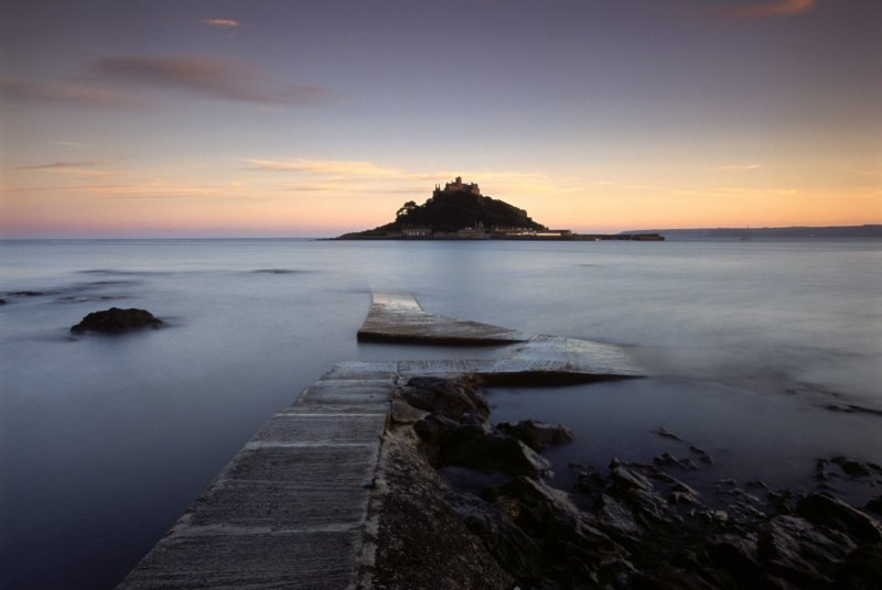 nationaltrust's tweet photo. The sun rises on the last day of September at St. Michael’s Mount in Cornwall. https://t.co/x2ft7TQQ9M