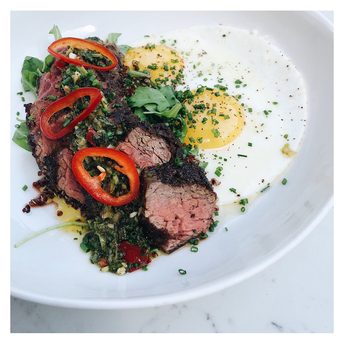 Perfect way to kick off the day? Our new, hearty &amp; delicious power bowl! filled with chimichurri steak strips, quinoa, arugula, and 2 fresh farm eggs. Mmm, mmm, mmm... now that's what we call #SundayBrunch done right! #basickitchen #charlestoneats #charlestonbrunch