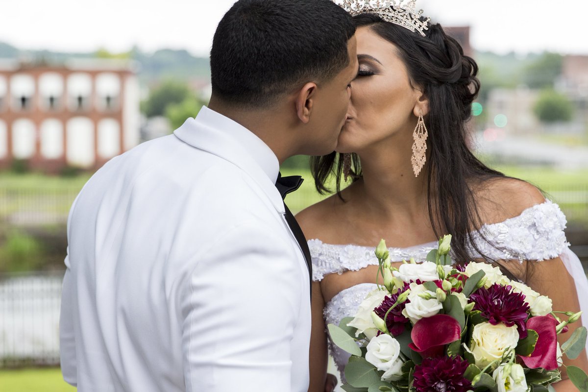 The moments when forgetting the world around you is what reminds you of why you love one another so much. #wedding #photography #style #cathedralveil #crown #queen #king #fashion #proudmarine #marinewife #earings #flowers #white #elegant #kiss #promise #red #focus #royalty #photo