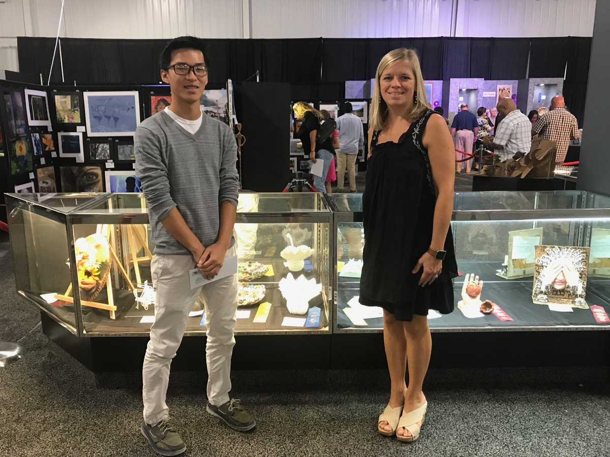 LexingtonTwo's tweet photo. Congrats to @BCHSBearcats Khai Truong (with art teacher Michelle Giovannone), who won a first place in the 3-D category at this year's @SCStateFair for an Origami Swan -- featuring 400-plus folded pieces! See other #LexingtonTwo student work on display. The fair opens Oct. 10. https://t.co/NLSpYb2ZIi