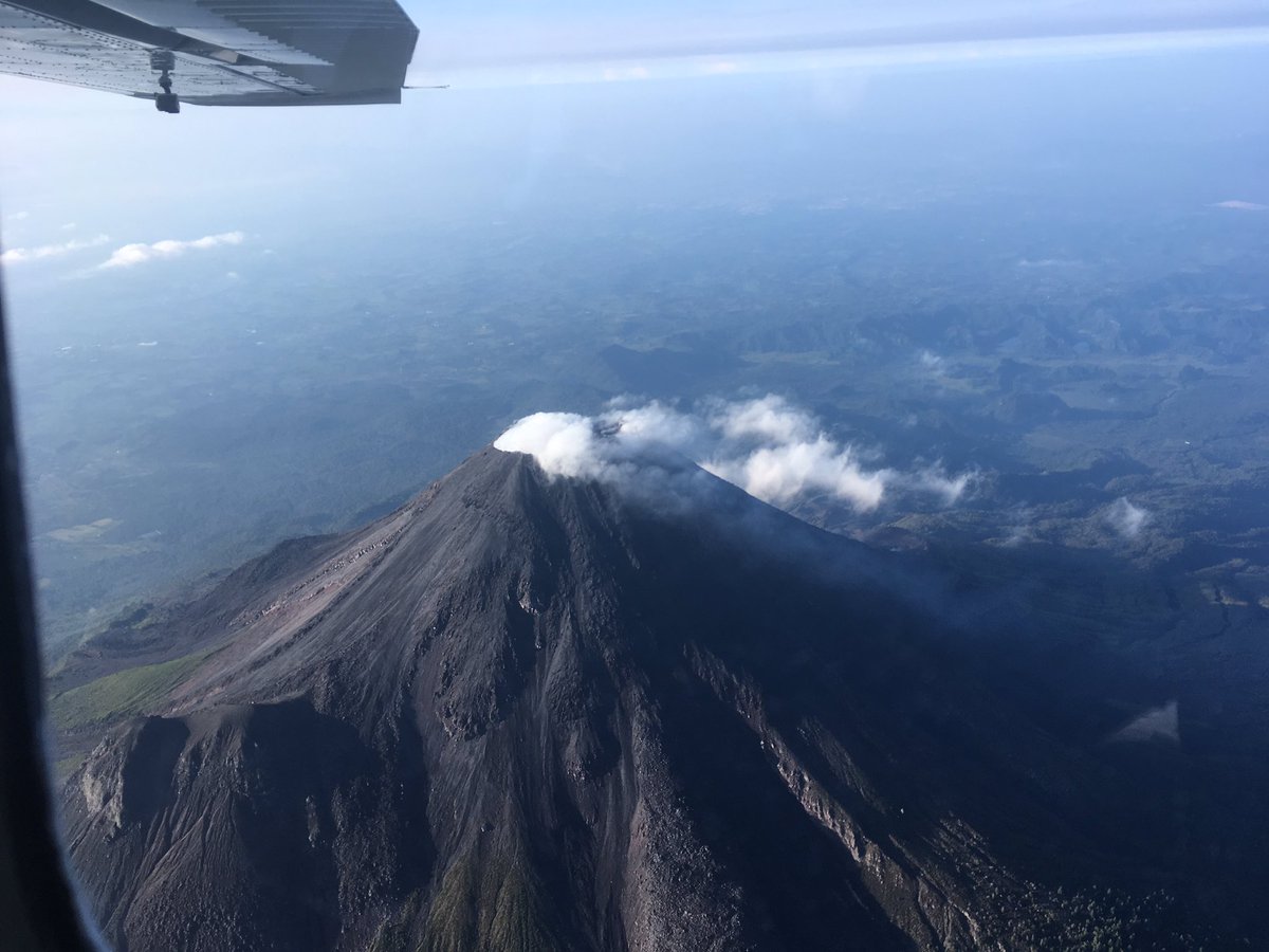The_Volcano_Guy's tweet photo. More photos from my flight around Volcán de Colima with Nevado &amp; the observatory in the background. Also a great shot of the Montegrande PDC visible down the flanks @CIIV_Colima #geology #lava #Colima #Mexico #flight #craterview #pyroclasticflow https://t.co/k7BTrLqXpa