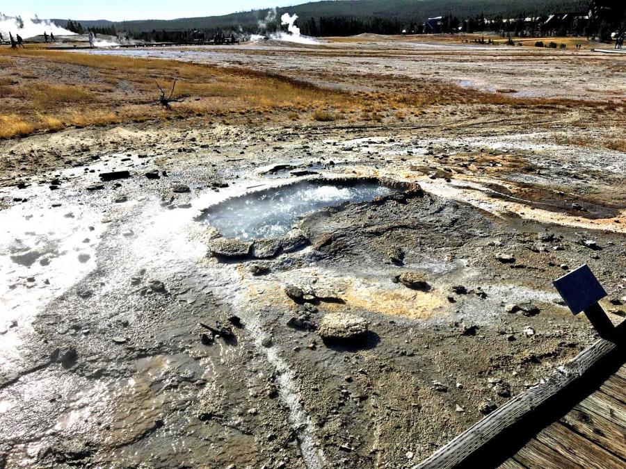 Ear Spring after an eruption of water and debris on September 15, 2018. The surrounding bacterial mats have been destroyed and large rocks are strewn around the area surrounding the spring.