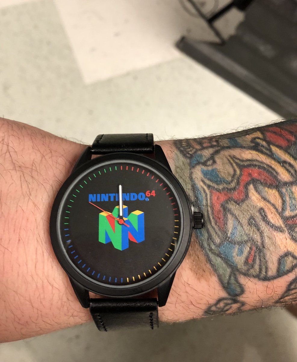 Testagaming's tweet photo. Loving my new @NintendoAmerica watch! #stylish #n64 #gamerwatch #collectibles #tattoos -Jake https://t.co/Am7ZQw9qXU