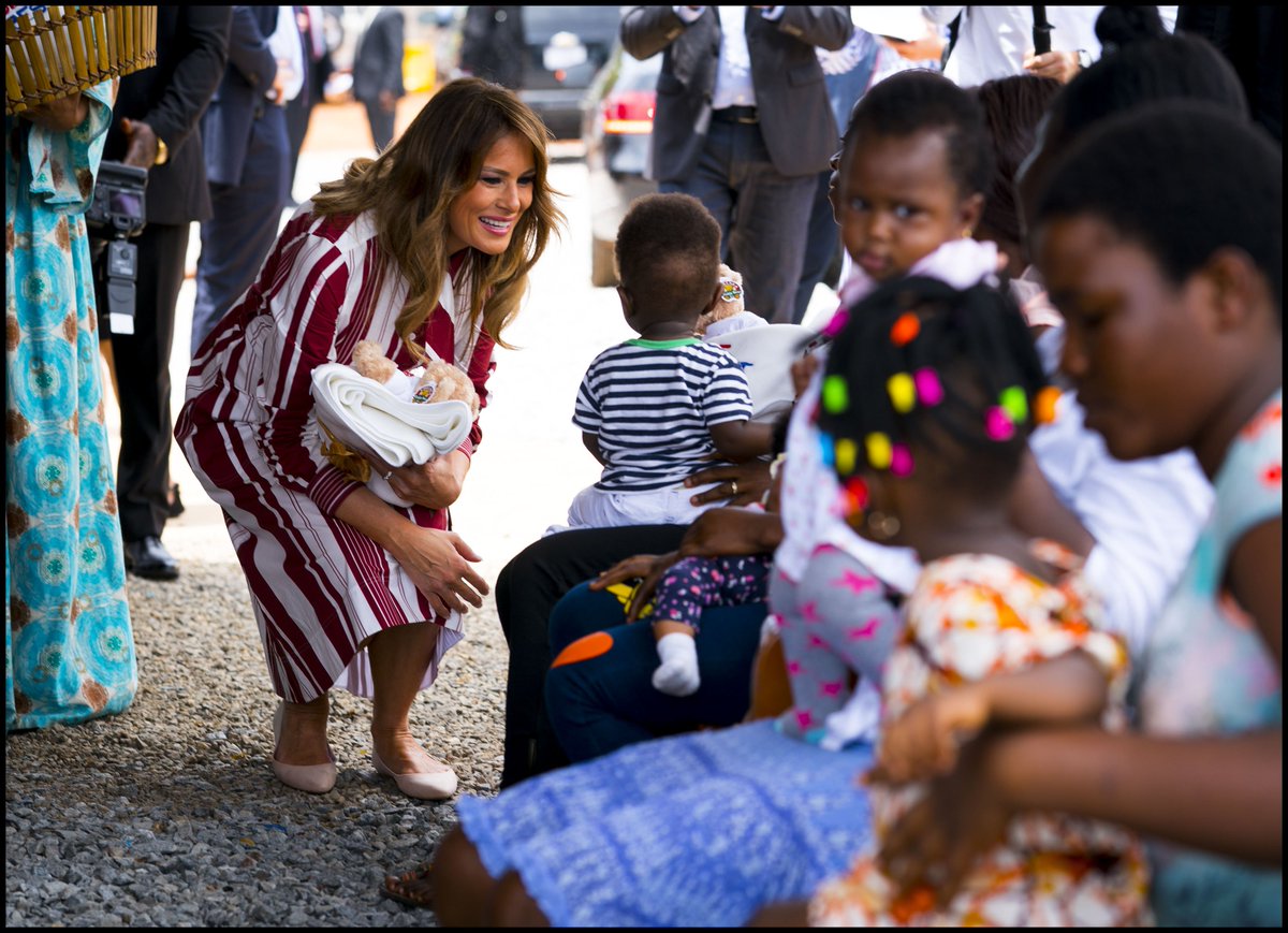 dougmillsnyt's tweet photo. .@FLOTUS speaks with young child as she hands out teddy bears and Be Best-themed blankets donated by the White House to young children and their mothers at the Greater Accra Regional Hospital in Accra, Ghana. #BeBest https://t.co/jh6erTOJei