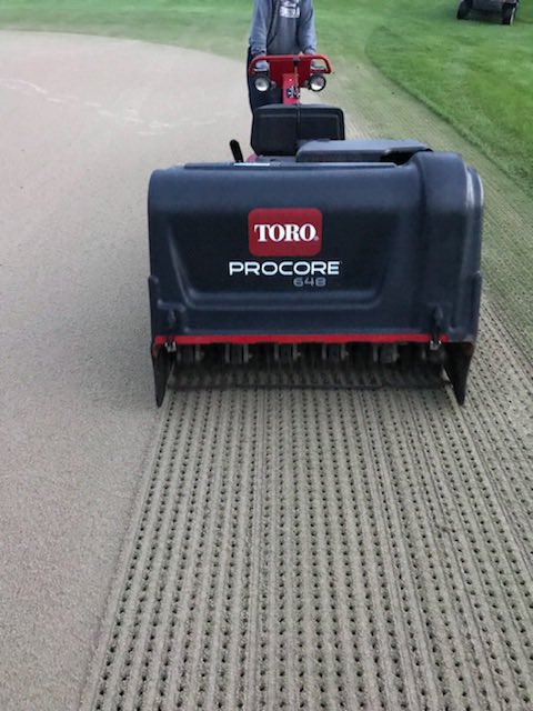 Not the best day for greens aerification!! But going smoothly!!!#cantwaitanylonger#flcc