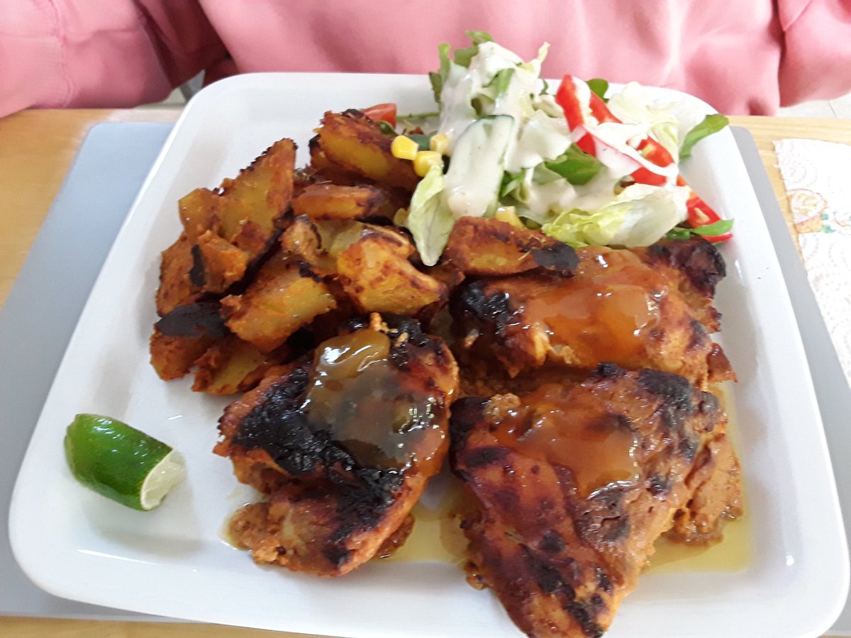 Homemade tandoori chicken thighs with bombay potatoes and salad