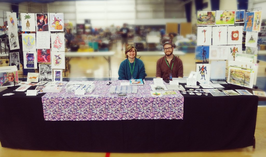 ethan_yazel's tweet photo. Glamour shot of @paisleydrawrs and me at #toycon2018, our first time tabling in an artist alley. Can't wait to do more this winter and next year. 

Thanks @zhjake for taking the picture and hanging out all day! 

https://t.co/dTen8Xdf1H
https://t.co/WlbPNkYFTq https://t.co/rUhpbo9yti