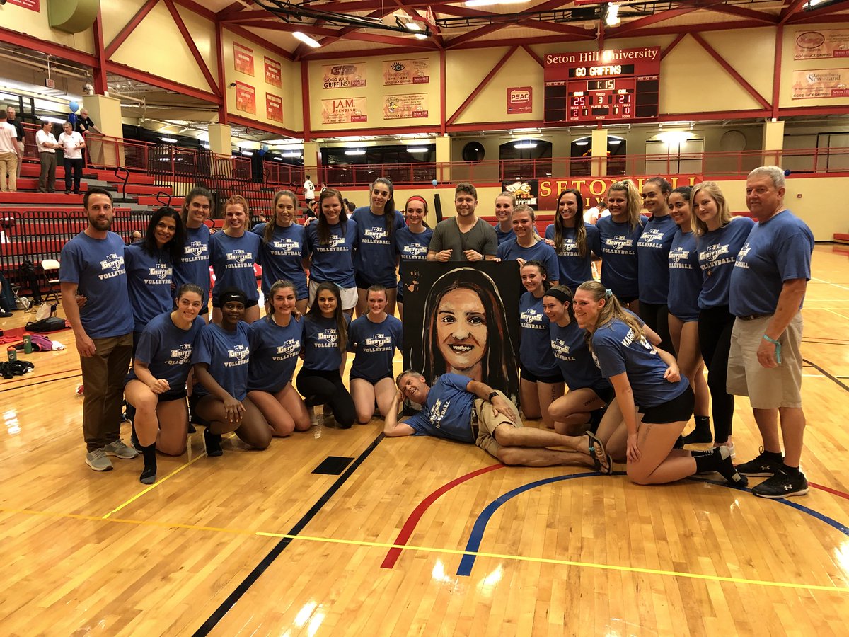 GriffinsSports's tweet photo. The @SHUvball team takes a group photo with a live painting of Maggie Murray done by Cody Sabol after their win over Cal (PA) https://t.co/MVtjodMv6W