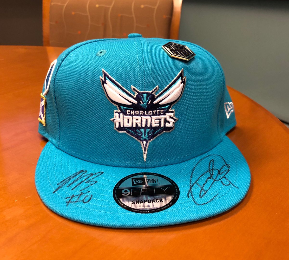 PeteGuelli's tweet photo. Who needs to add this to their collection? Signed by our 2 @hornets rooks Miles Bridges and Devonte’ Graham. RT, like or comment. Will pick a winner tomorrow. #BuzzCity https://t.co/gI2DbFryu3