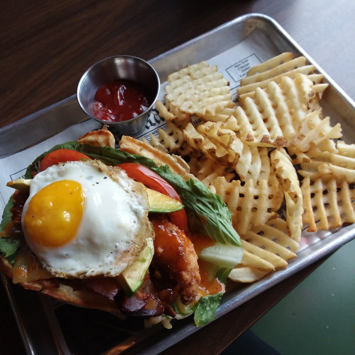 #WaffleWednesday Special: Kitchen Sink, fries and drink $9 + tax. Kitchen Sink: Hand breaded fried chicken, lettuce, tomato, bacon, colby jack cheese, avocado, wrapped in a waffle and topped with Sink Sauce and an over easy egg. $2 Domestics til 9pm.