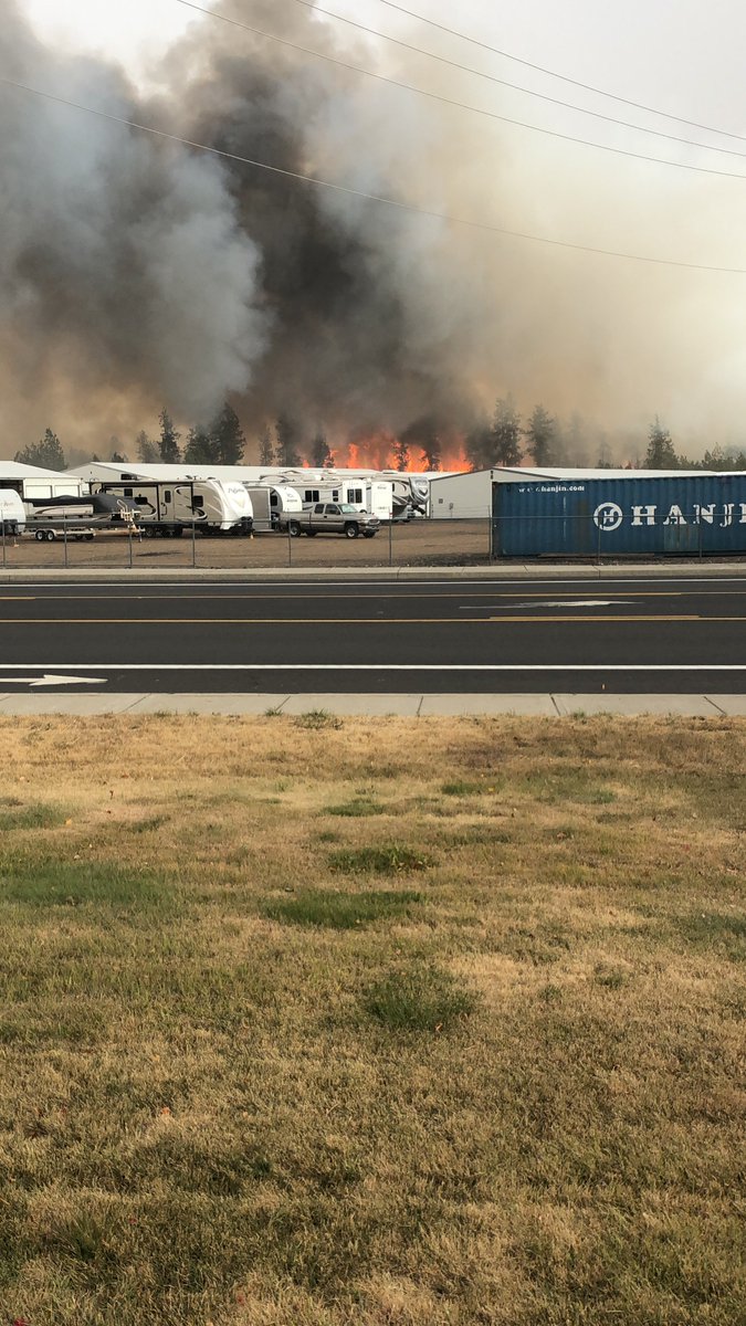CheneyFreePress's tweet photo. Right outside the @CheneyFreePress offices, the #MullinixFire is gaining ground. What started as a small brush fire near the railroad tracks has caught the wind and turned into a blaze requiring road shutdowns and response from multiple agencies. @waDNR_fire @CheneyFF1919 https://t.co/E9GxQucgYv