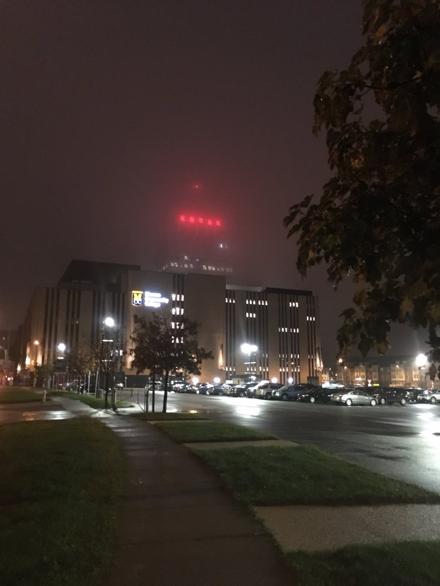 Kodak still peering down on the city through a murky fog.