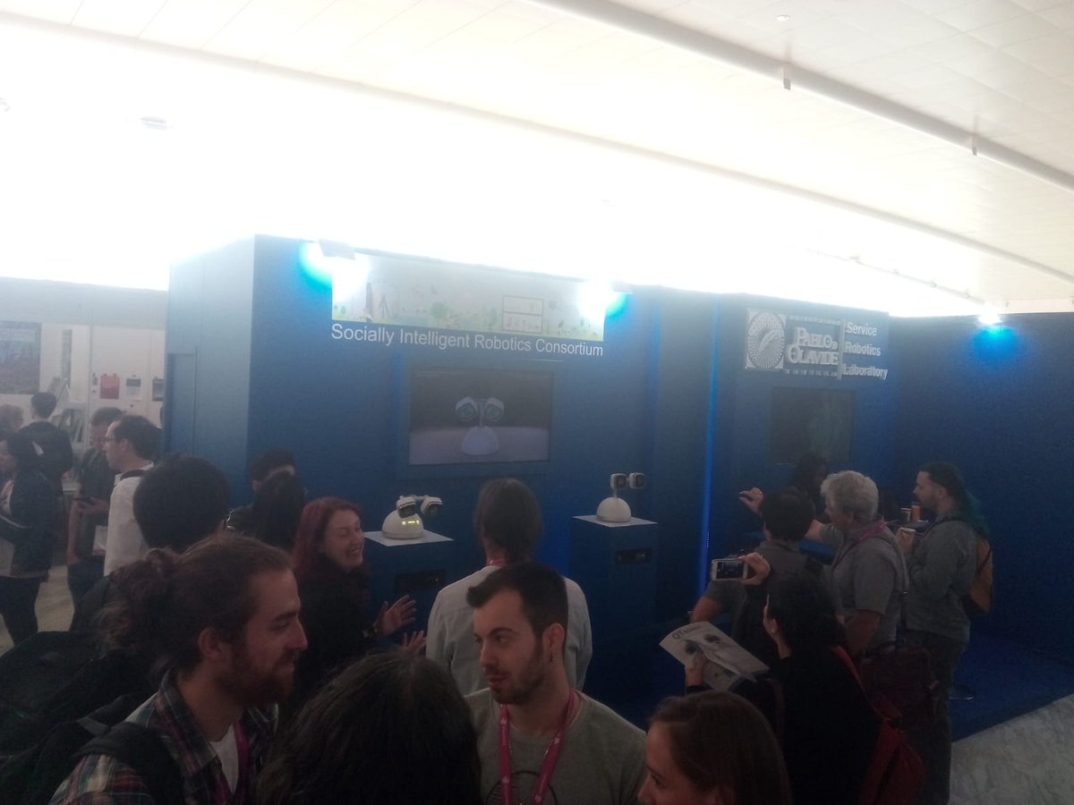 Busy day at #IROS2018 ! People gather around to see an interaction robot build at <a href="/IDMindRobots/">IDMind</a> at <a href="/pablodeolavide/">Pablo de Olavide</a> 's booth Socially Intelligent Robotics Consortium !

#Robots #socialrobotics #IROS2018 #idmind #pablodeolavide