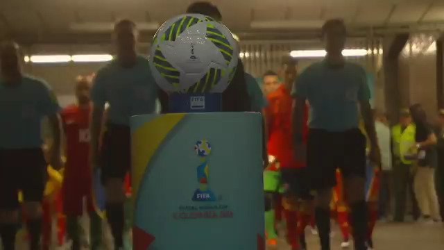 Referees walk out on pitch.