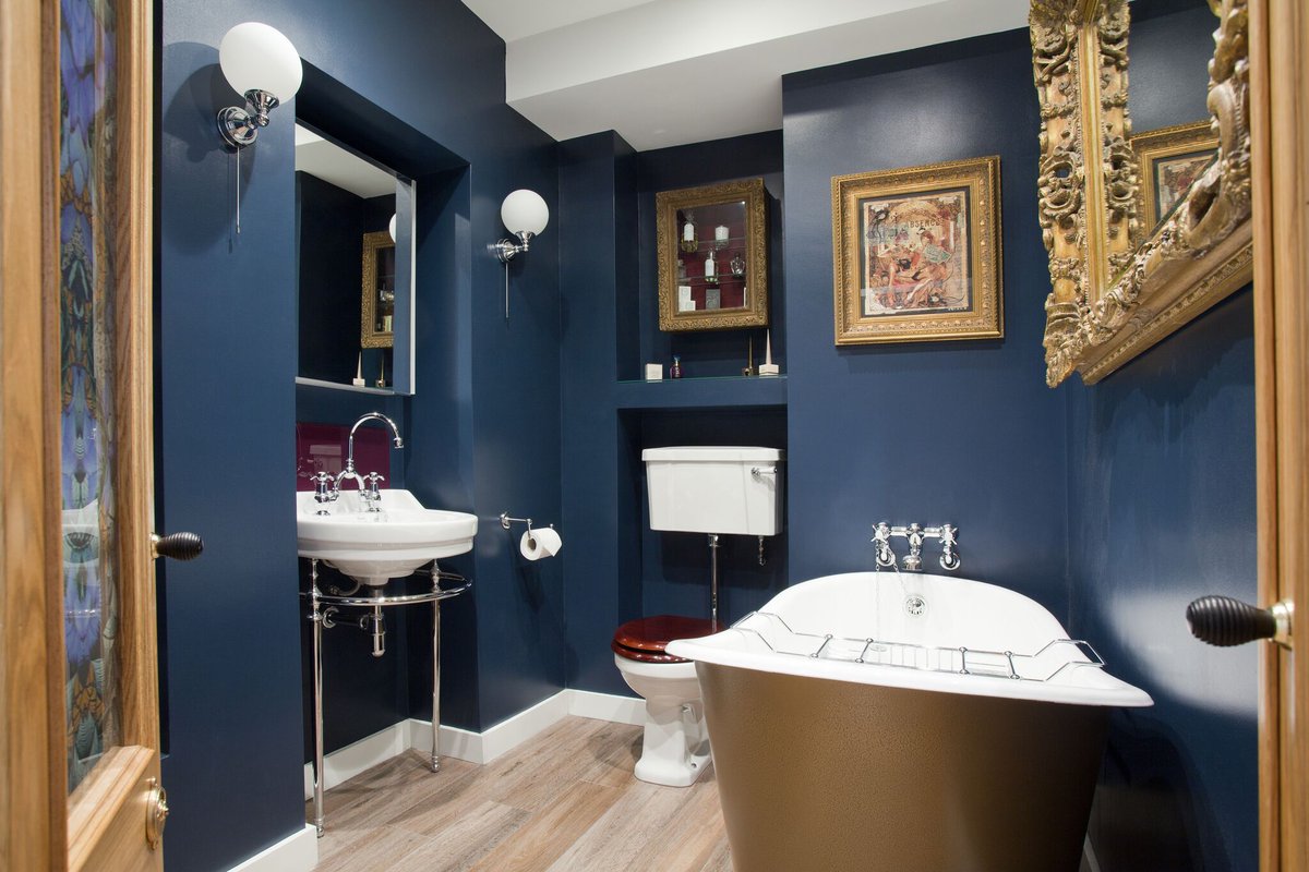 This Boudoir themed bathroom is truly unique. These dark blue walls are rich with colour, creating an indulgent, relaxing space. It's the perfect place to have a candle lit bath at the end of a long day. #bathroominspo