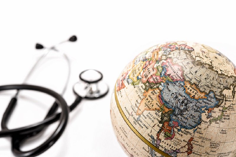 Stethoscope next to a model globe