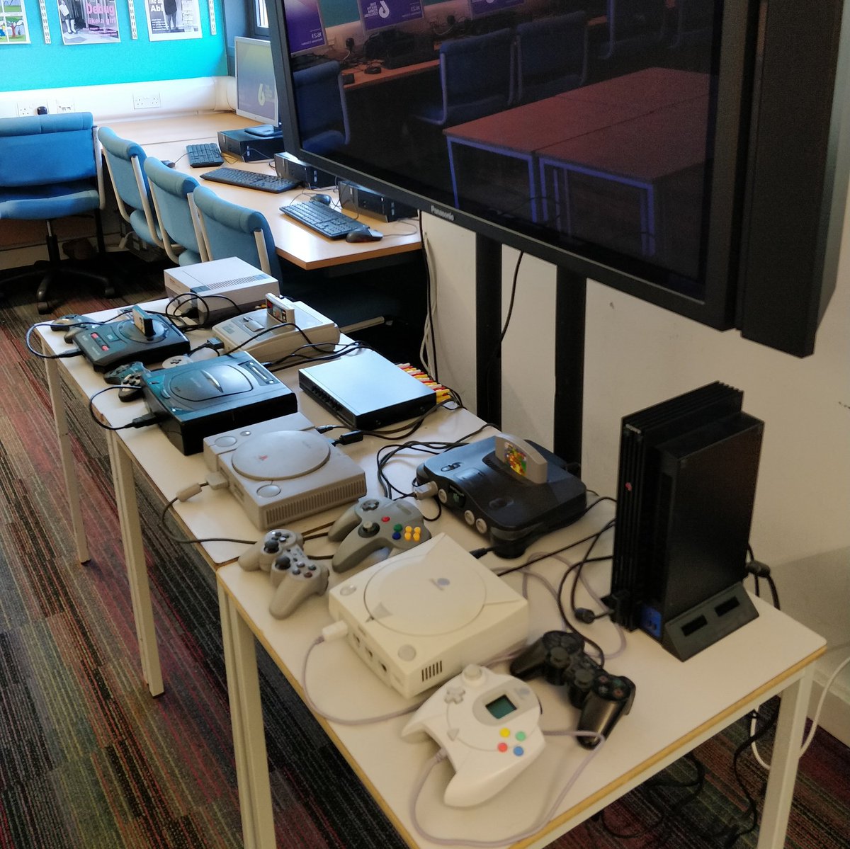 cgc6th's tweet photo. The octuple retro games console setup is ready for the open days, and we're only just getting started #computerscience @Farnborough6th https://t.co/CplWJQ1N1Q