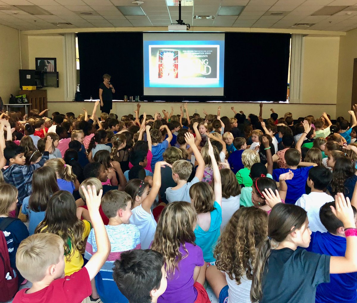 elizlenhard's tweet photo. When @lisa_mcmann poses a question to Oakhurst Elementary students, she prefers that they raise their hands like snakes. Just what you’d expect from the author of the #GoingWild series. #ClashOfTheBeasts @HarperChildrens @lilshopostories https://t.co/IRMtTjNaS6