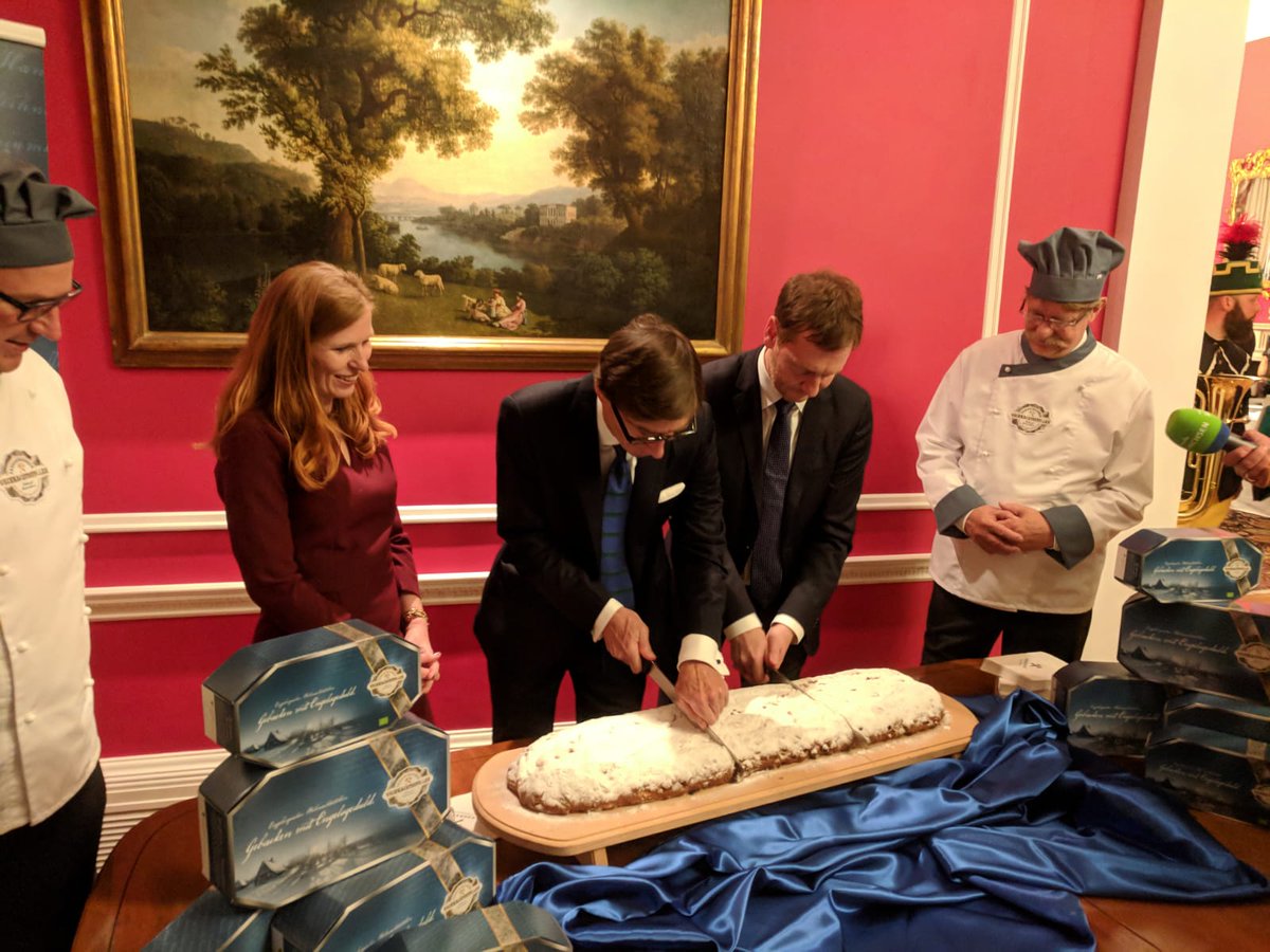 GermanEmbassy's tweet image. Ambassador Wittig and @MPKretschmer cutting the original Dresden Christstollen, a true German Christmas delicacy #GermanUnityLDN