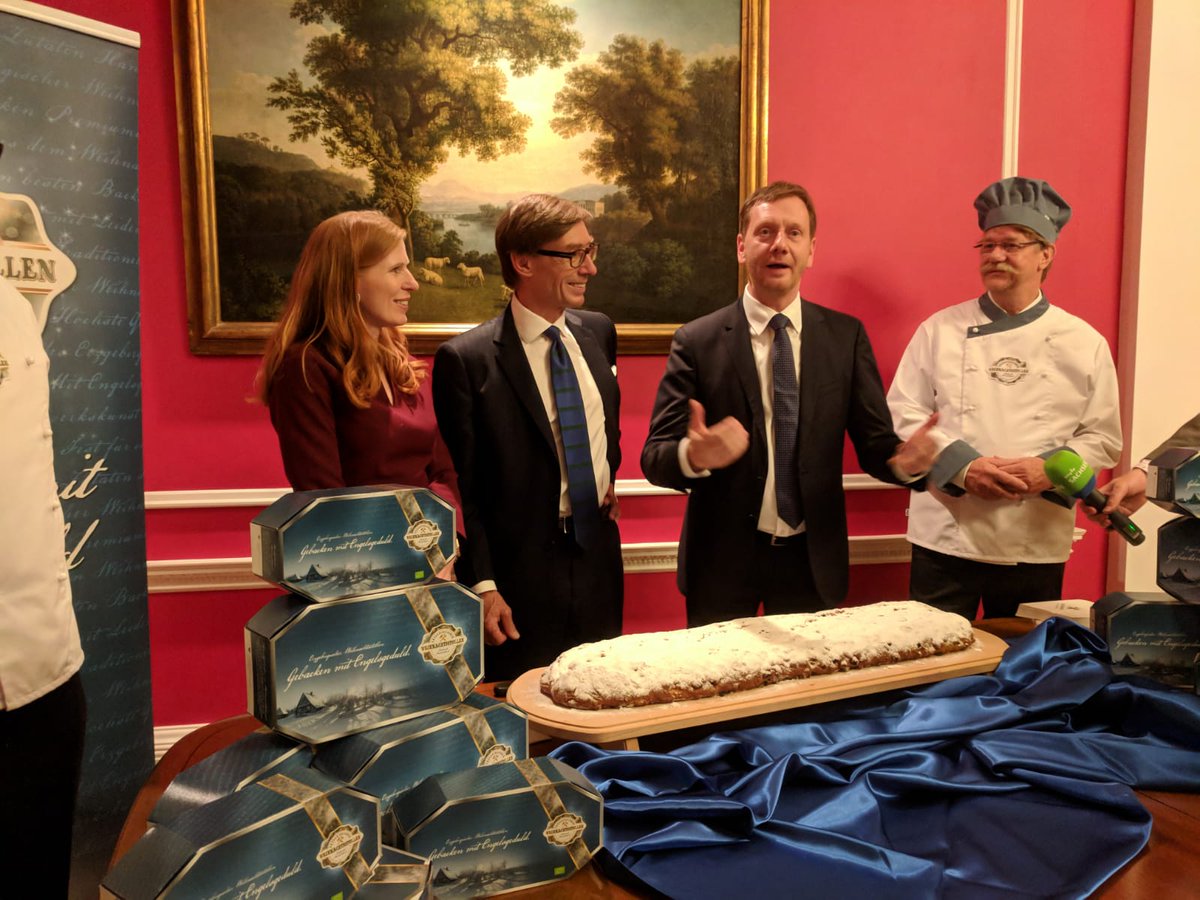 GermanEmbassy's tweet image. Ambassador Wittig and @MPKretschmer cutting the original Dresden Christstollen, a true German Christmas delicacy #GermanUnityLDN