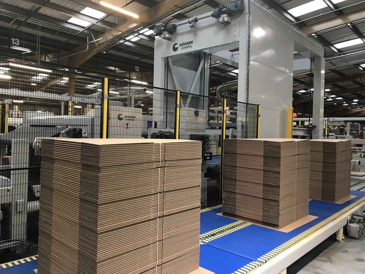 Three stacks of cases exit the Dücker corrpal from CM4. Impressive automation and the cases look a high quality finished product.