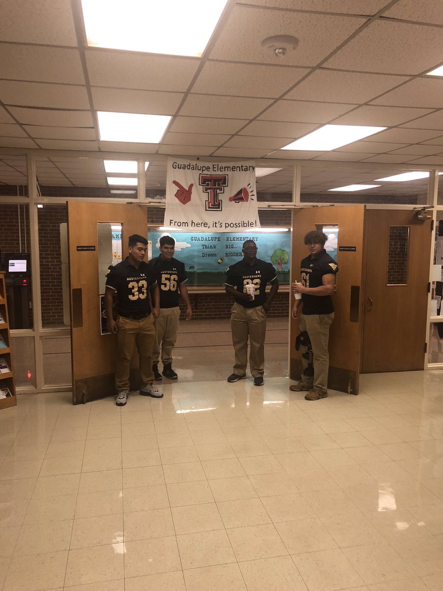 Game day. Westerner Football Players opening doors for Guadalupe Elementary