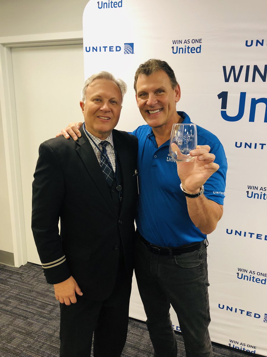 LAX Flight Attendant Robert Briggs presenting one of the 120 engraved glasses he gave away to celebrate October 1st.