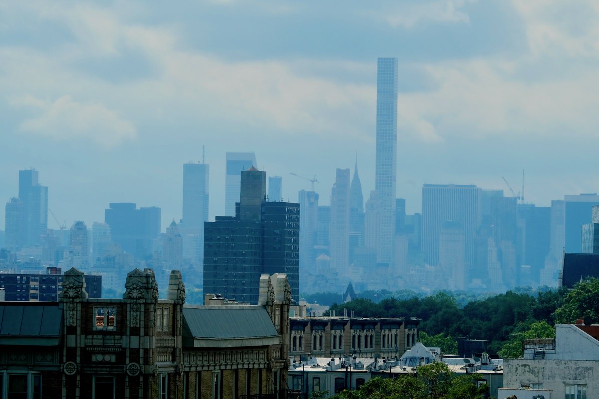 #Harlem roofs and #Midtown skyline under partially cloudy skies, 12:46 p.m. #NYCweekend