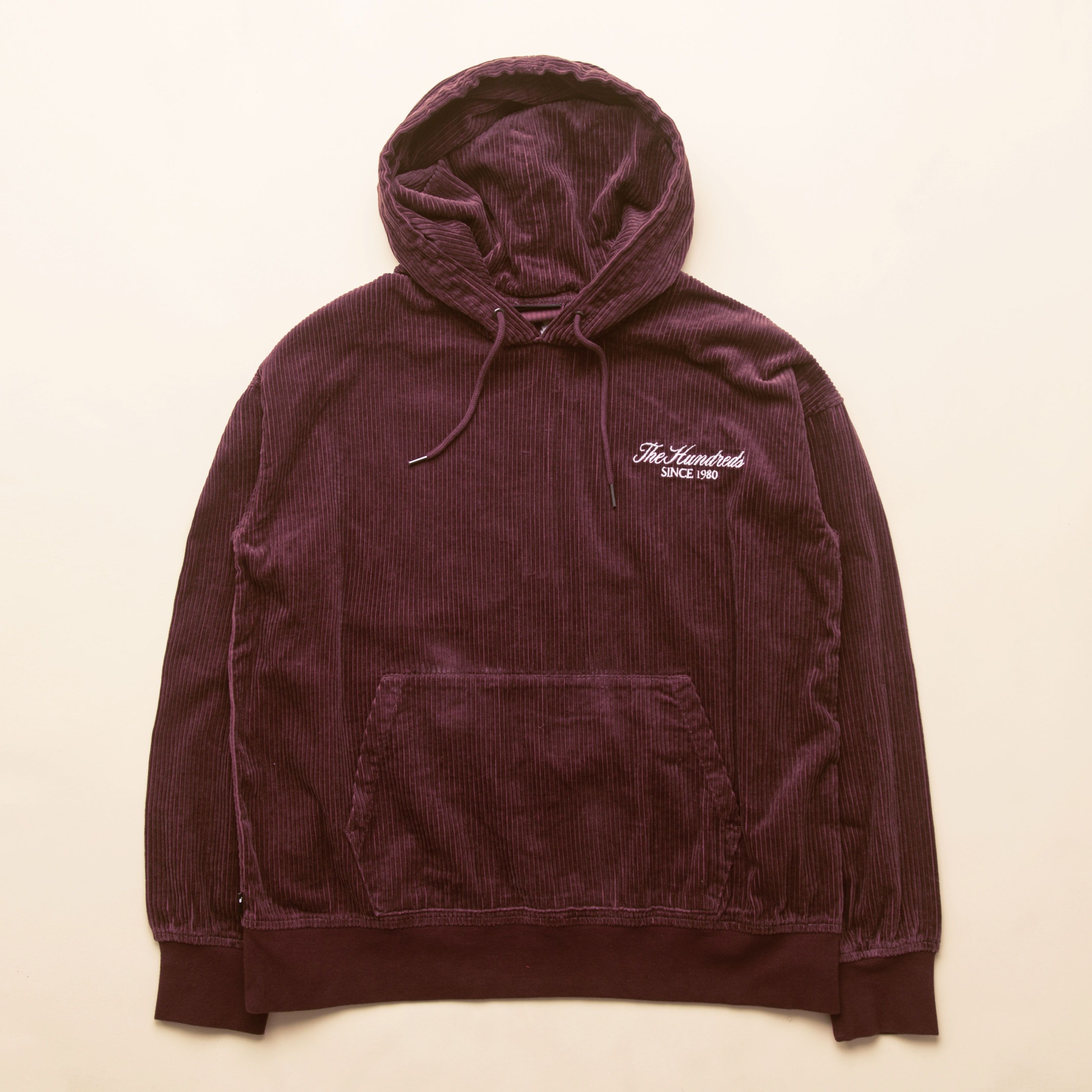 The Hundreds on X The corduroy Cypress pullover hoodie features a Rich logo embroidered on the left chest and comes in black and eggplant colorways. Oversized fit. Available now with The