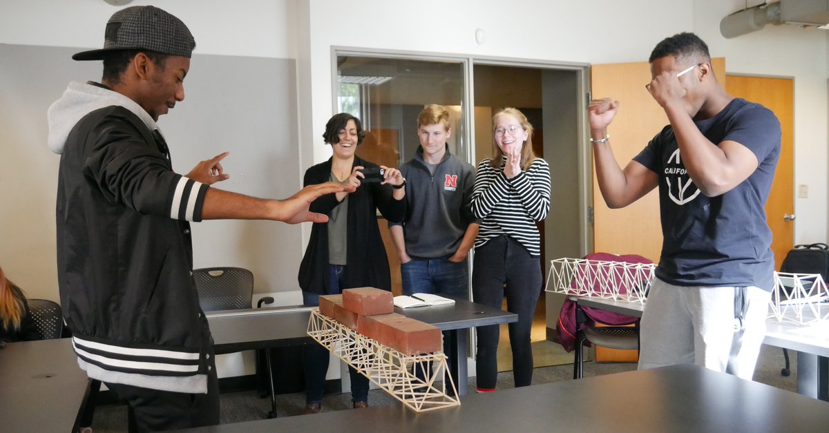 UNLarchitecture's tweet photo. Cathy De Almeida Materials class is testing their basswood bridge structures today. Here are the highs and lows of today's challenge! #unl #unlarchitecture #structurechallenge @UNLincoln https://t.co/15qBheX69a