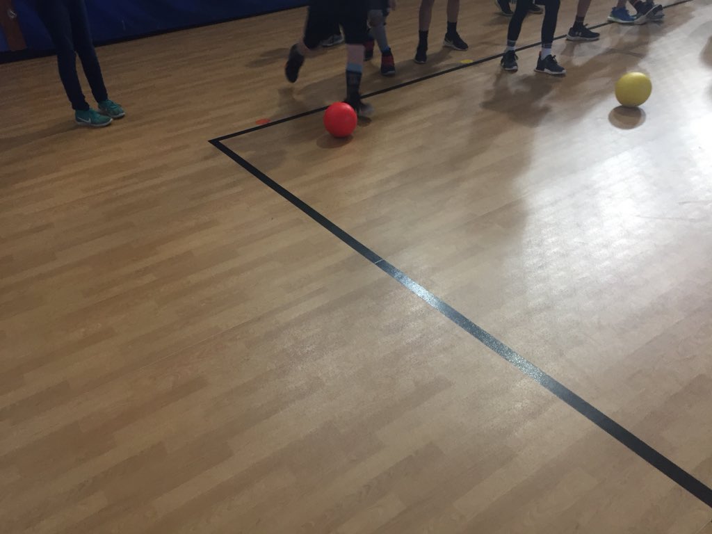 SHEHuskyPE's tweet photo. “Pin Soccer” today. Kick your ball, if you knock over the pin you move it one line closer to your opponent. If it makes it all the way to their goal line you win and they do 5 push-ups. https://t.co/9rwmQNYqLj