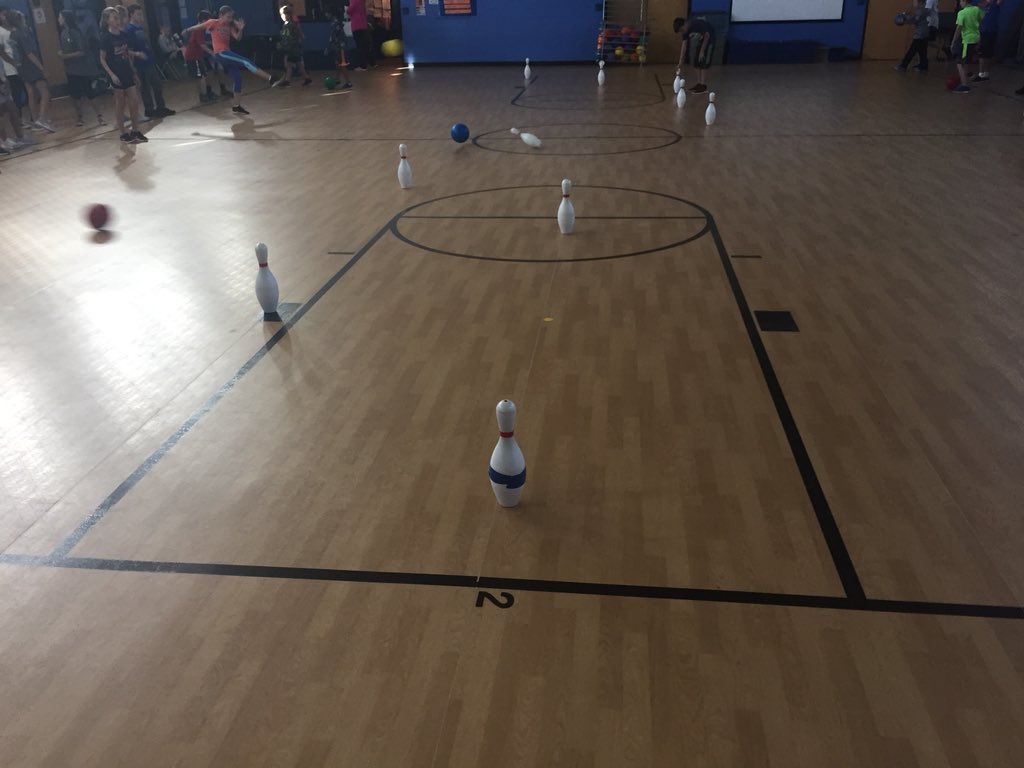 SHEHuskyPE's tweet photo. “Pin Soccer” today. Kick your ball, if you knock over the pin you move it one line closer to your opponent. If it makes it all the way to their goal line you win and they do 5 push-ups. https://t.co/9rwmQNYqLj