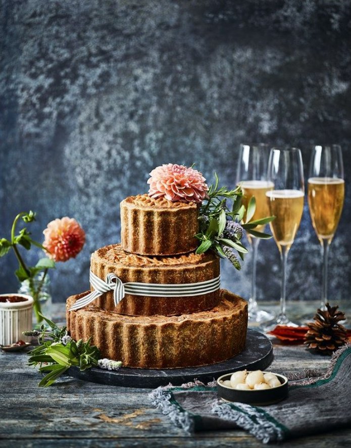 marksandspencer's tweet photo. Dreaming of a celebration cake to impress? How about three tiers of succulent pork pie covered in golden pastry? Introducing our biggest (and tallest) pork pie yet! Guaranteed to surprise your guests at any event. 😋 https://t.co/MnUKsvTELC