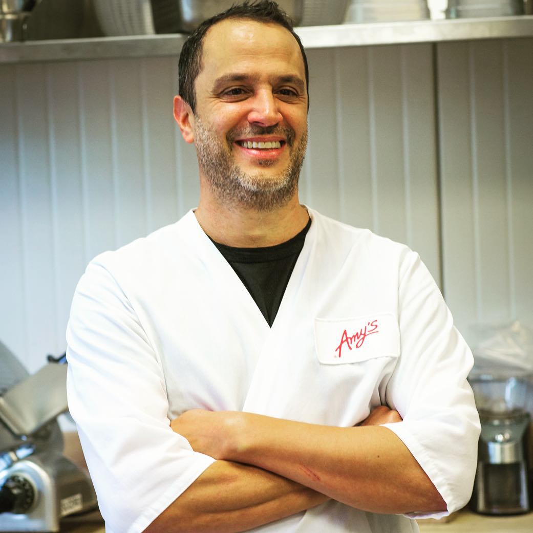 AmysKitchen's tweet photo. We’re looking ahead to #InternationalChefsDay tomorrow with a nod to our head chef Fred Jr. This guy works tirelessly to perfect every recipe we make. Let’s give it up for Fred Jr. and all of the great work he does to make the some of the tastiest meals around! #ChefsDay #FredJr https://t.co/h2ITU2f6jw