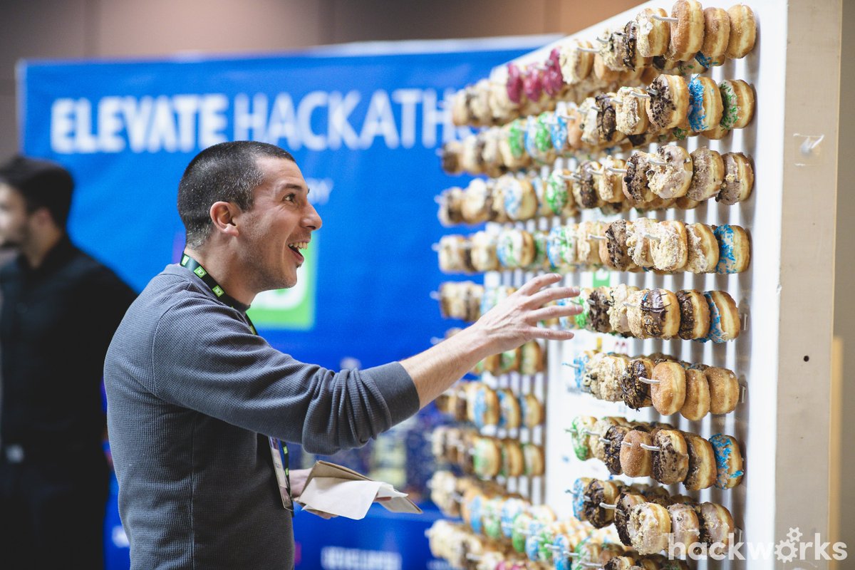 HackworksInc's tweet photo. Happy Thanksgiving everyone! This day of course brings food to mind. Like the amazing doughnut wall at the #ElevateHackathon. Clearly that's the reason we run #hackathons. #werenuts #fordoughnuts https://t.co/r6sfmKa1dL