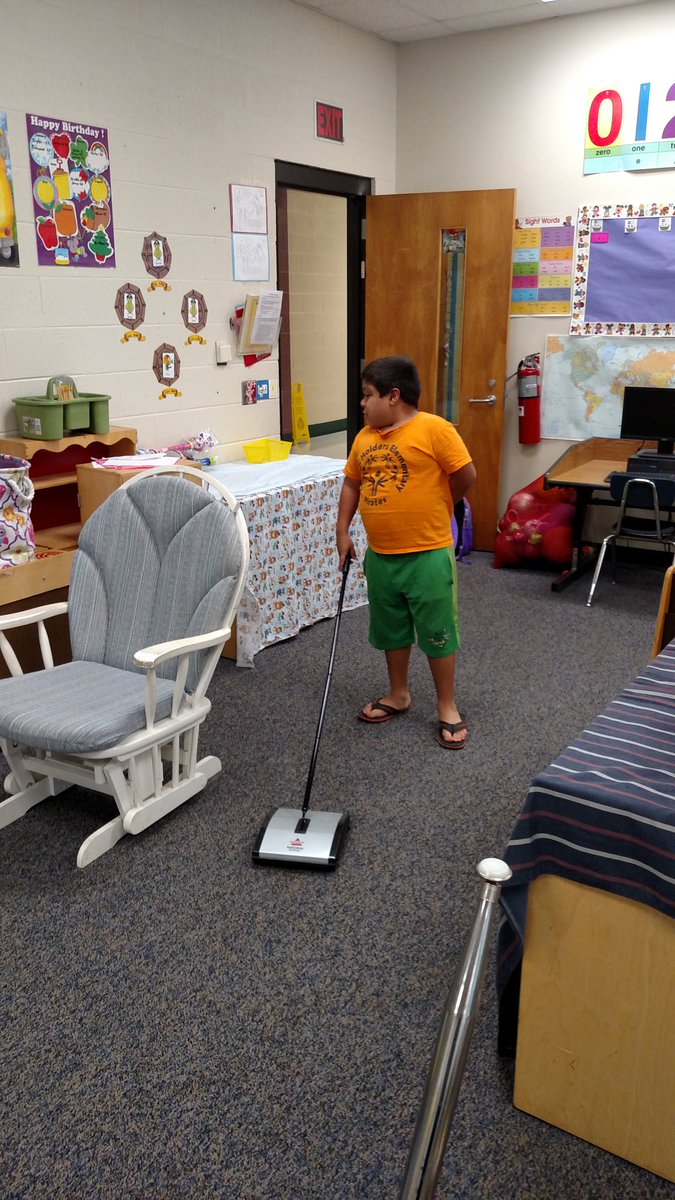 My student doing his part to keep our room and school clean.