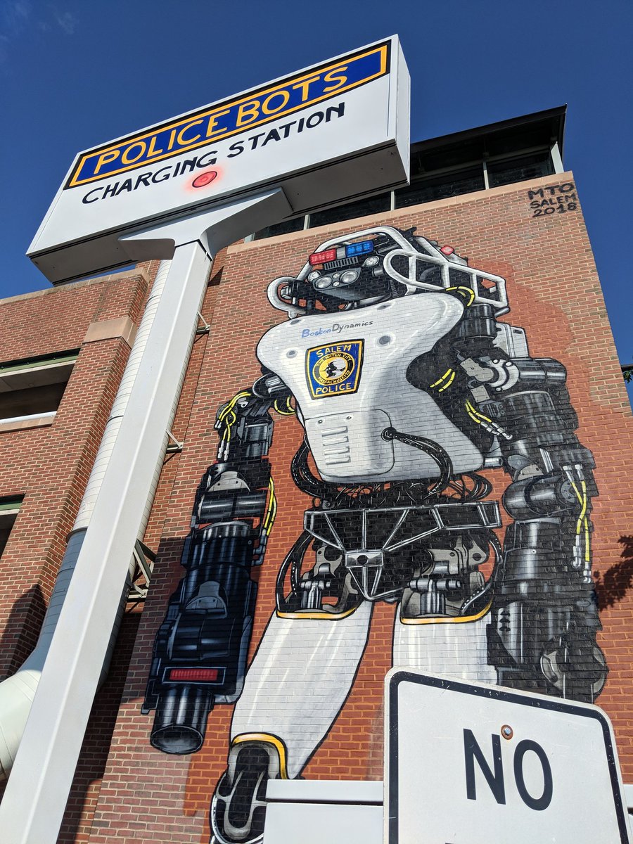 meghanehuber's tweet image. My town of Salem, MA has a new mural (a @BostonDynamics Atlas dressed up for Halloween is my personal interpretation). PRO-TIP: If you need to evade one of these policebots, just run (or walk) away. They don&apos;t actually have a vision system :) #robotfacts