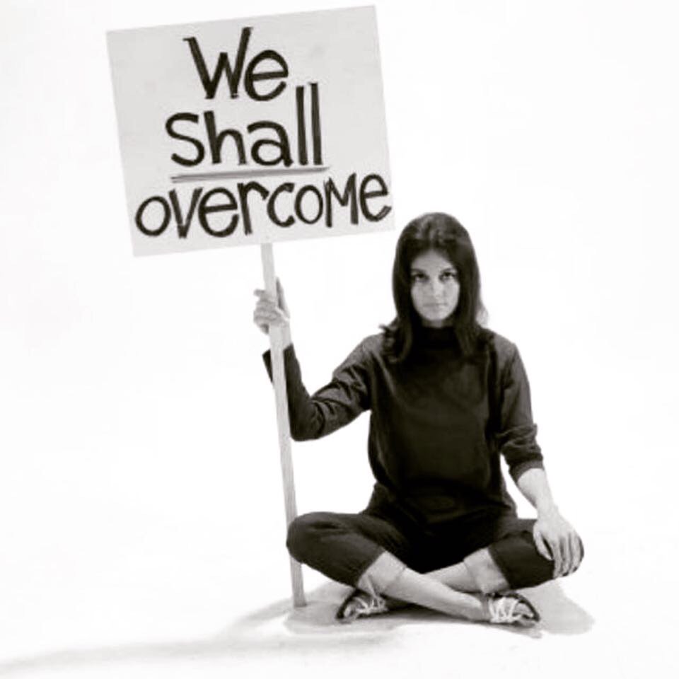 VoicesofHopeNE's tweet photo. Women's rights activist Gloria Steinem posed for LIFE magazine in 1965 to remind us that no matter the obstacles that stand between us and equality, "we shall overcome." Today Everly, granddaughter of a staff member, poses with the same message, just relevant today as in 1965. https://t.co/63YVwTXyYh