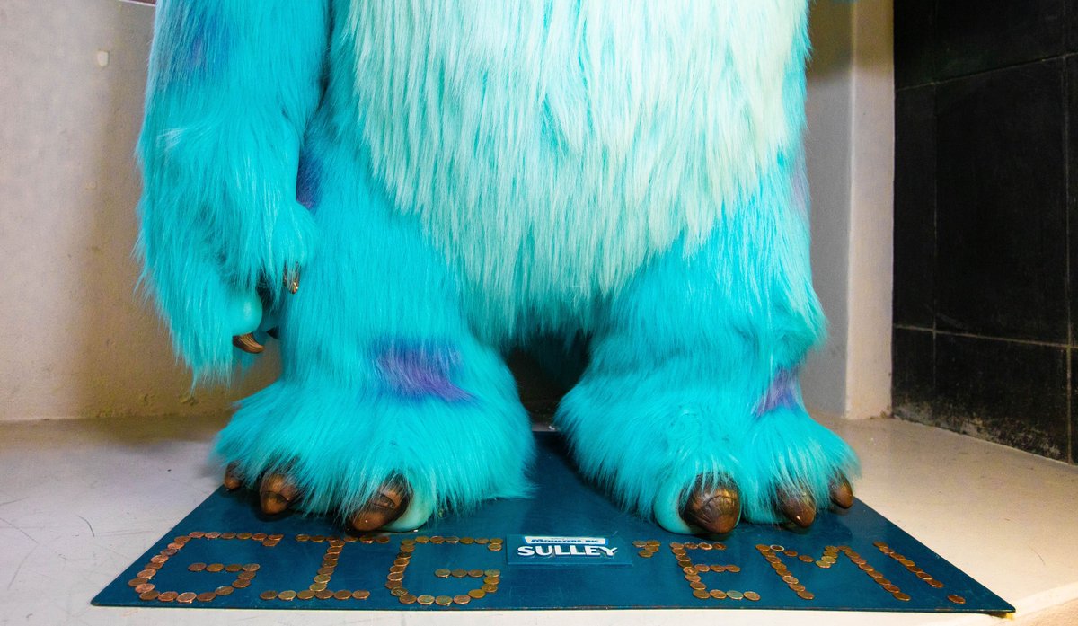 Sulley's feet with pennies spelling Gig 'Em around them