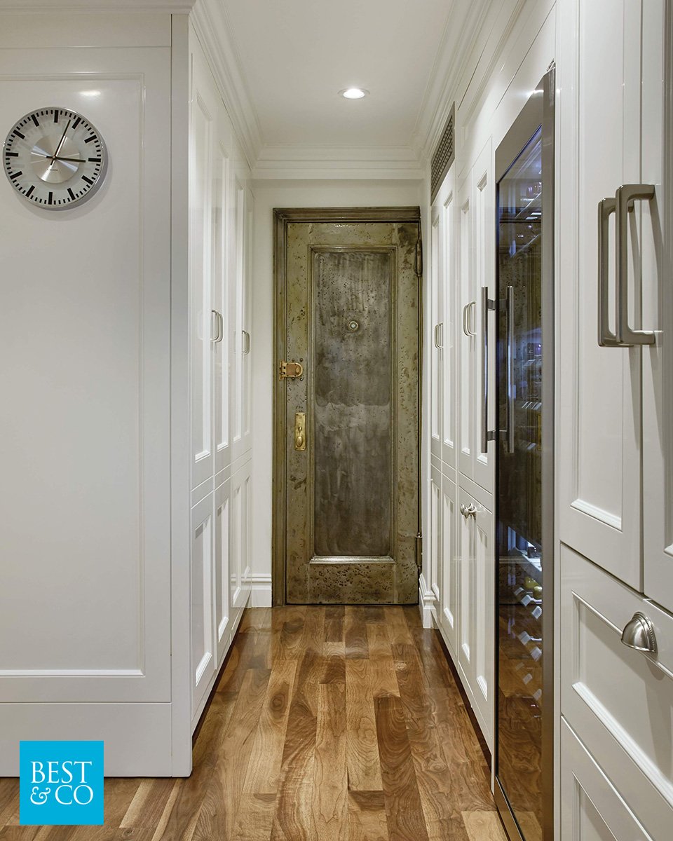 This refurbished front door was one of our favorite things to work with. The aged coloring and brass accents look so great in this modern kitchen!