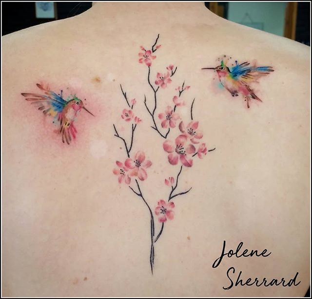 Watercolor style apple blossom tattoo on the left foot